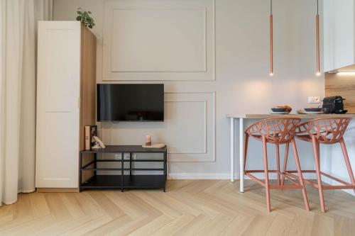 a kitchen with a table and two chairs and a television at Good Mood Francuska Retreat - FREE PARKING - Self check-in in Katowice