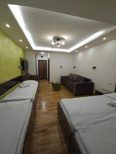a hospital room with two beds and a couch at Apartments JAT Kopaonik in Kopaonik