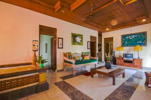 a living room with a couch and a table at Ume Sita Villa and Homestay in Ubud