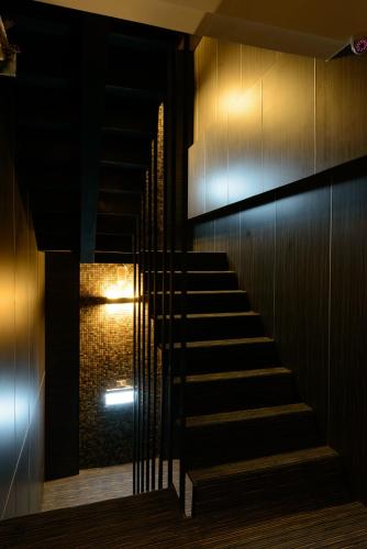a staircase in a building at night with a light at Poshpacker Hotel in Taipei