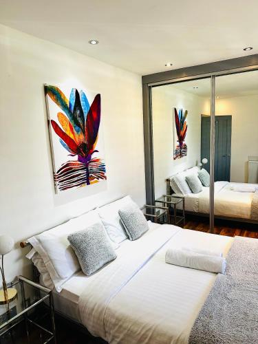 a bedroom with two beds and a mirror at Grace Court in Aberdeen