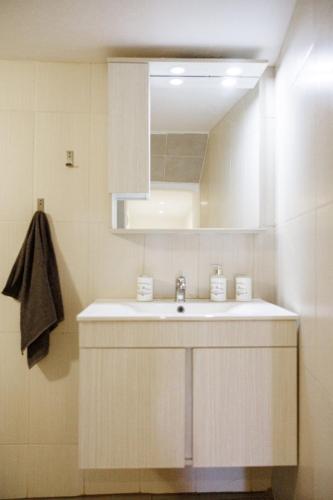 a bathroom with a white sink and a mirror at Isalos view in Skiathos