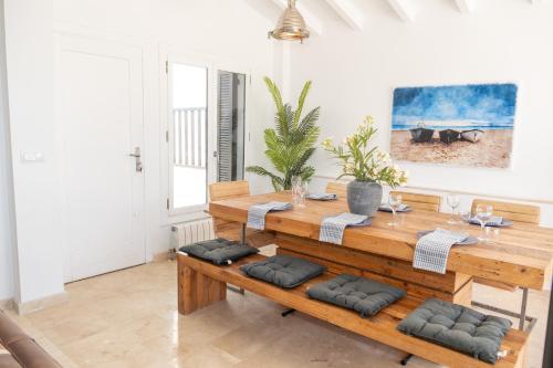 ein Esszimmer mit einem Holztisch und Bänken in der Unterkunft Casa Trebol - Private Pool Villa in San Javier