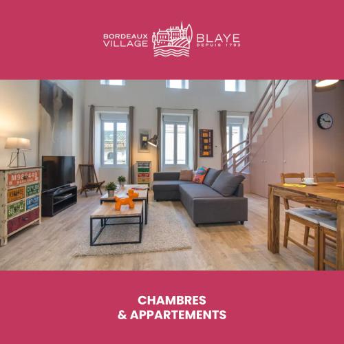a living room with a couch and a table at Bordeaux Village Blaye in Blaye