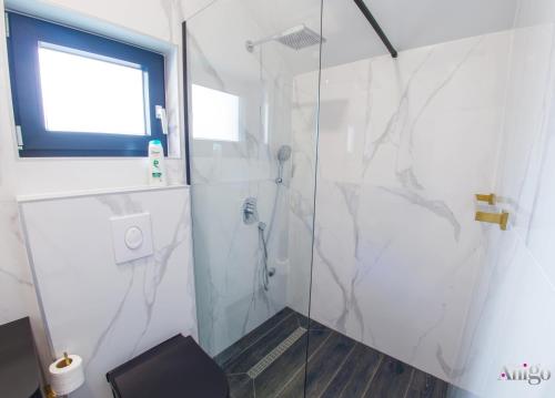 a bathroom with a shower with a glass door at Bunska Venera in Blagaj