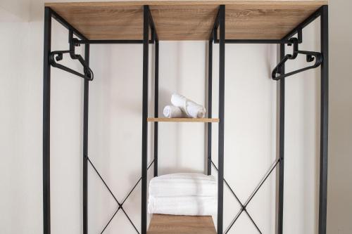 a room with a shelf with a white chair at Santo Stefano Loft in Bologna