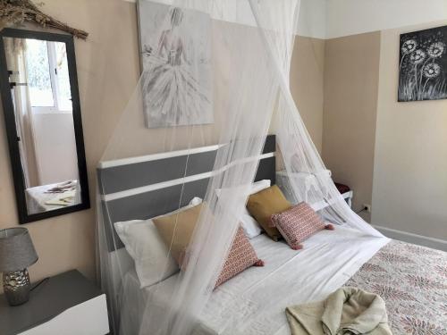 a bedroom with a canopy bed with pillows on it at Sea Mountain House in Machico