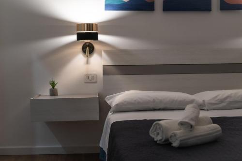 a bedroom with a bed with a towel on it at Vela Rossa Deluxe Apartment in Trapani