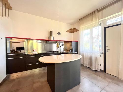 a kitchen with a island in the middle at Pineta Apartament in Tirrenia