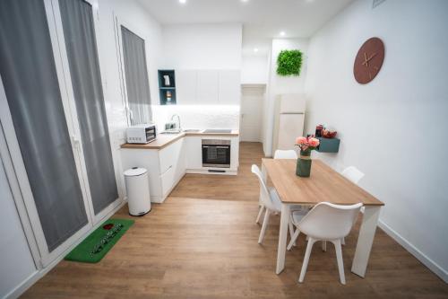 a kitchen and dining room with a table and chairs at Vela Rossa Deluxe Apartment in Trapani