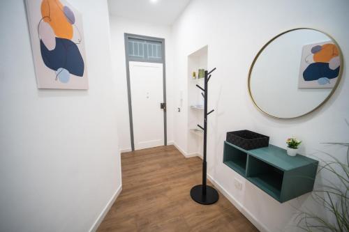 a hallway with a mirror and a green shelf at Vela Rossa Deluxe Apartment in Trapani