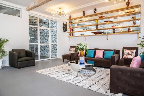 a living room with couches and a table at Dunas Boutique Hotel in Kololi