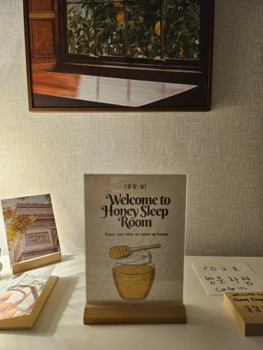 a book on welcome to honey step room on a table at Honey Sleep Room - 2BR Cosy House at Jamsil, FreeParking in Seoul
