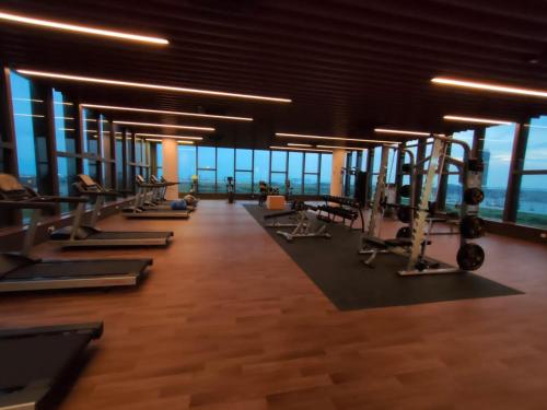 a gym with a row of treadms and machines at Bali Melaka SeaView WaterPark 2-5Pax 5minJonker Projector in Melaka