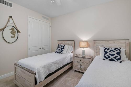 a bedroom with two beds and a lamp on a night stand at Last Mango in Bradenton
