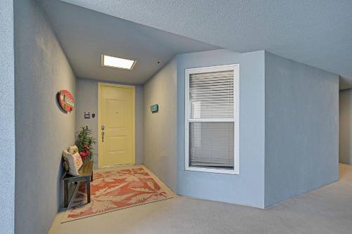 a hallway with a yellow door and a window at Last Mango in Bradenton
