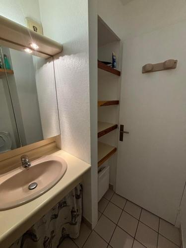 une salle de bain avec un lavabo et un miroir dans l'établissement Appartement studio 4 personnes dans résidence avec piscine, à Quiberon