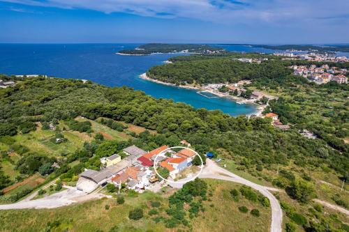 an aerial view of a house on a hill next to the water at Apartman Punta Verudella in Pula