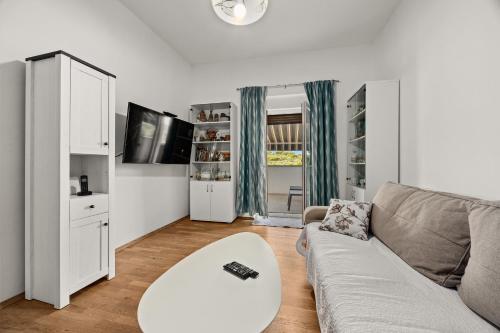 a living room with a couch and a table at Apartman Punta Verudella in Pula