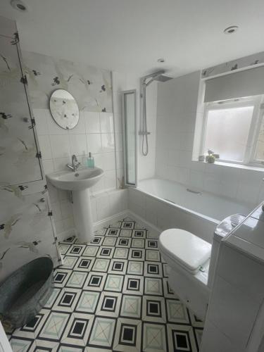 a white bathroom with a toilet and a sink at Poets Place - lovely 4 bedroom townhouse with garden in Brighton & Hove