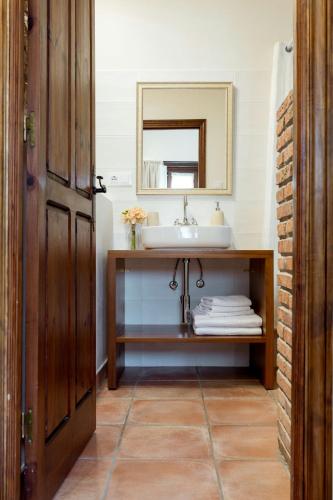 a bathroom with a sink and a mirror at El Molino de Bonaco in San Vicente de la Barquera