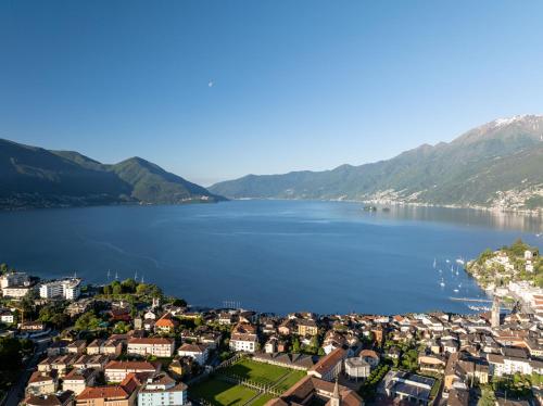 a view of a town on the shore of a lake at Suite Stays by Hotel La Perla in Ascona