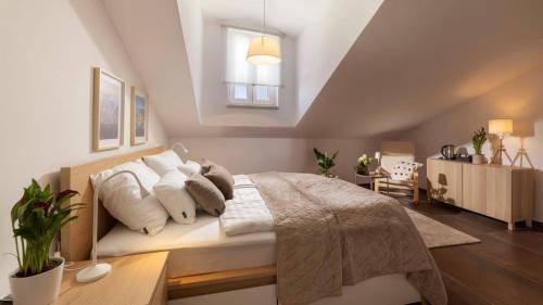 a bedroom with a large bed with white pillows at La Grisha in Mali Lošinj