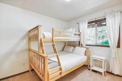 a bedroom with two bunk beds and a window at Rhododendron Retreat with Hot Tub Steps to River! in Rhododendron