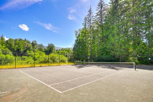 a tennis court with a net on it at Rhododendron Retreat with Hot Tub Steps to River! in Rhododendron