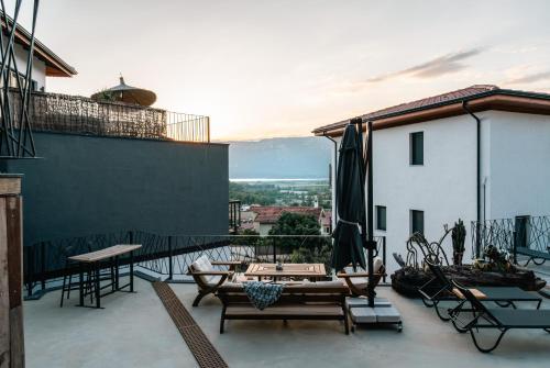 a balcony with tables and chairs on a building at Kikonia Art & Suites in Akyaka