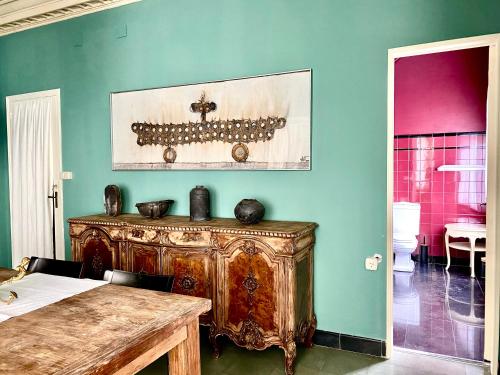 a room with a wooden table and a blue wall at Carmen Guillemot in Alcanar