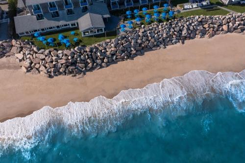 an aerial view of a beach with rocks and the ocean at Pleasant View Inn in Westerly