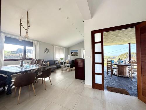 a living room with a table and a living room with a view at Vela Bianca - 12807 in Ajo