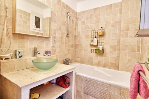 La salle de bains est pourvue d'un lavabo et d'une baignoire. dans l'établissement Grand T2 avec une magnifique vue mer et JO, à Marseille