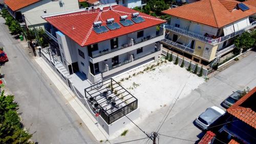 an overhead view of a building with a red roof at LA PLAZA luxury suites NEA VRASNA in Nea Vrasna