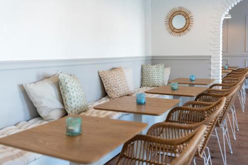 a row of tables and chairs in a restaurant at Inselpension Henriette in Norderney
