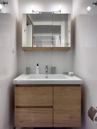 a bathroom with a sink and a mirror at Aphrodites Place in Messini