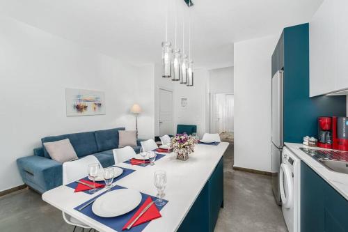 a living room with a blue couch and a table at Aphrodites Place in Messini