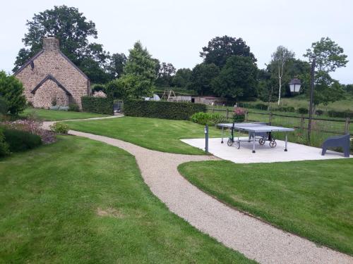 a park with a picnic table in the grass at Gite de la Houssière in Joué-du-Bois