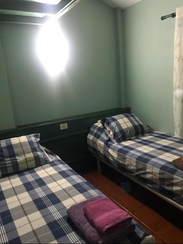 a room with two beds and a light on the wall at Casa El Pajar 1 in El Pinar del Hierro