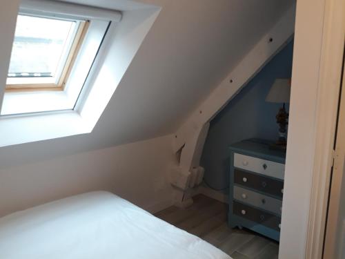 a bedroom with a bed and a window and a dresser at Gite de la Houssière in Joué-du-Bois