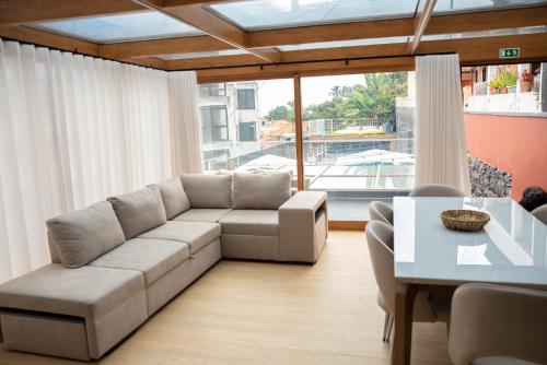 a living room with a couch and a table at HOMELIKE FUNCHAL II in Funchal