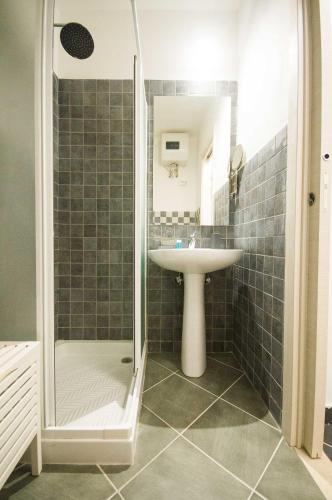 a bathroom with a sink and a shower at San Domenico Appartaments in Noto