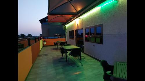 a balcony with a table and chairs on a building at Deluxe Twin Beds in Royal Blue Guest House and Bar Lome in Lomé