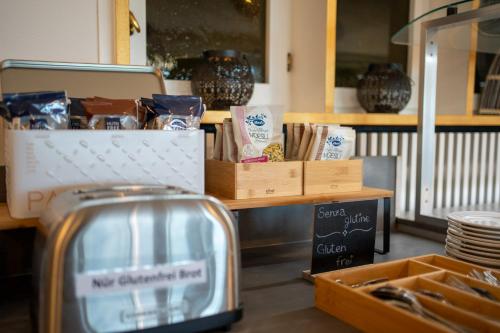a kitchen with a toaster and boxes of food at Easy Stay by Hotel La Perla in Ascona