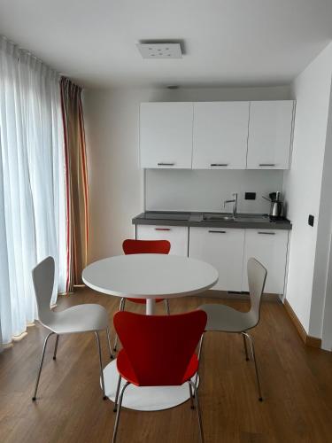 a kitchen with a table and four chairs at BB Hotels Aparthotel Isola in Milan