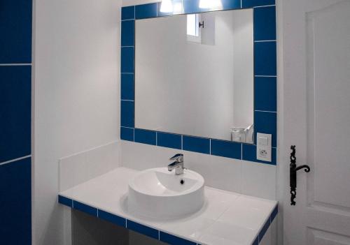 a bathroom with a white sink and a mirror at Est in Colonzelle
