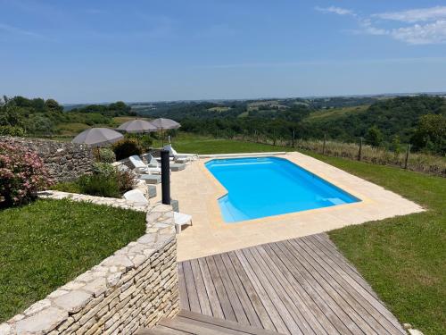 VielleségureにあるChambre d'hôtes Domaine Cherps Spa et piscineの石壁の庭のスイミングプール