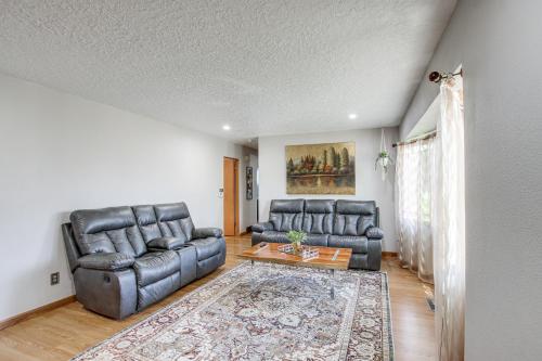 a living room with two leather chairs and a table at Walk to Park Waterloo Home with Furnished Deck in Waterloo