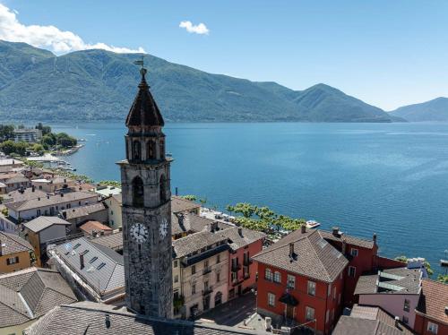 an aerial view of a town with a clock tower at Easy Stay by Hotel La Perla in Ascona